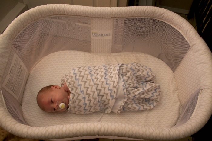 newborn baby inside HALO Bassinest Swivel Sleeper 
